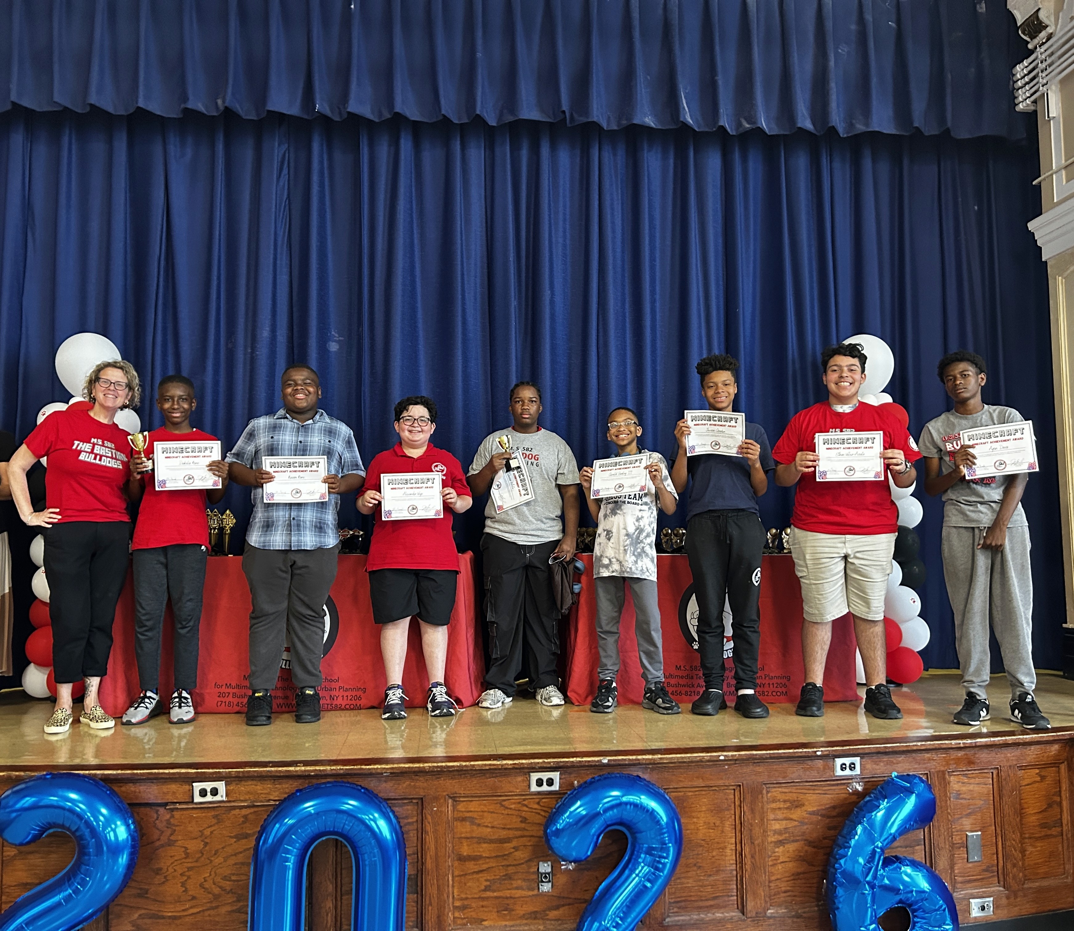 Students receive certificates commendingg their work in extracurricular activities.