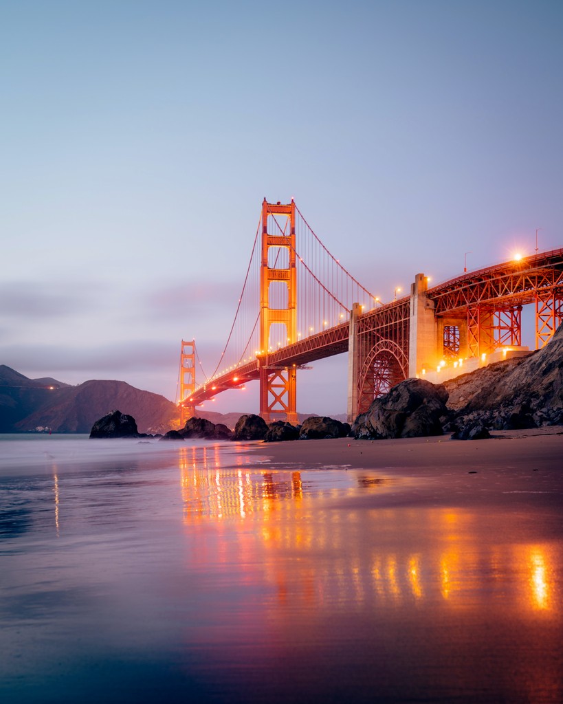 Sandy beach with golden gate bridge in the background on a clear evening 