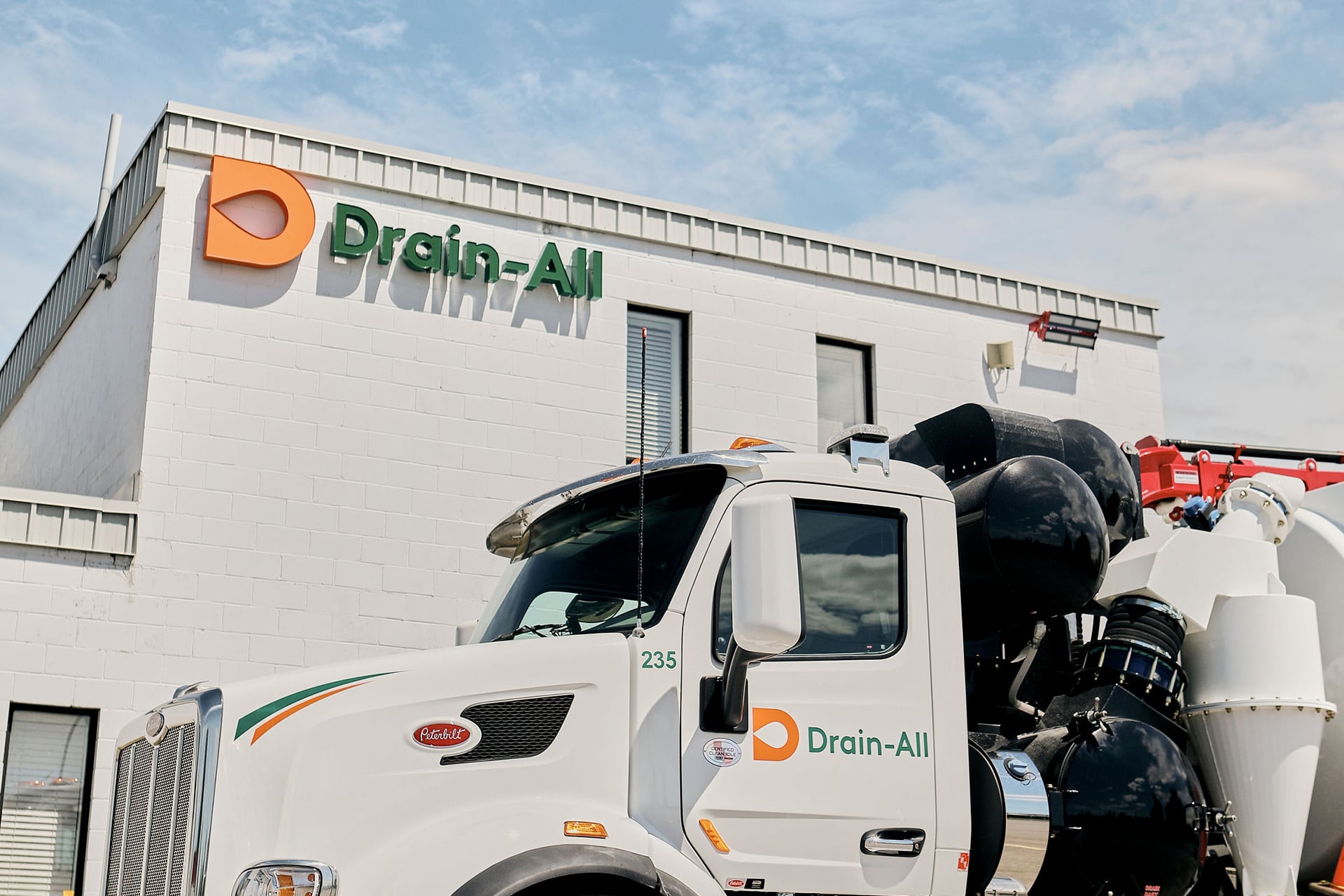 Drain-All logo sign on facility building and truck.