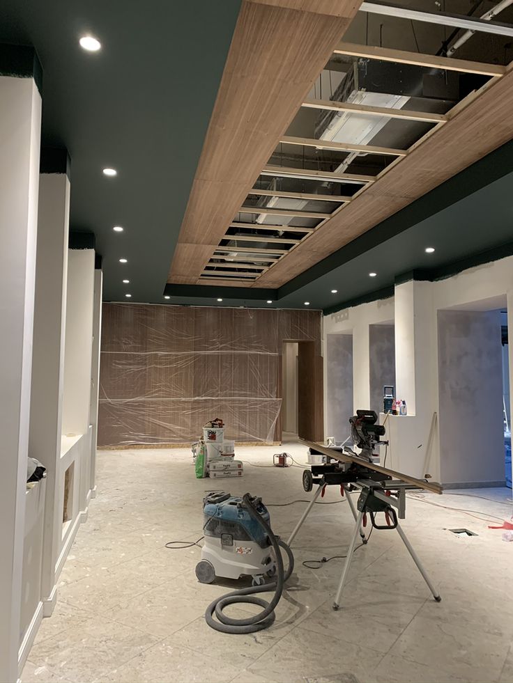 Modern bathroom featuring a walk-in shower, wooden vanity, round mirror, and elegant marble tiles.