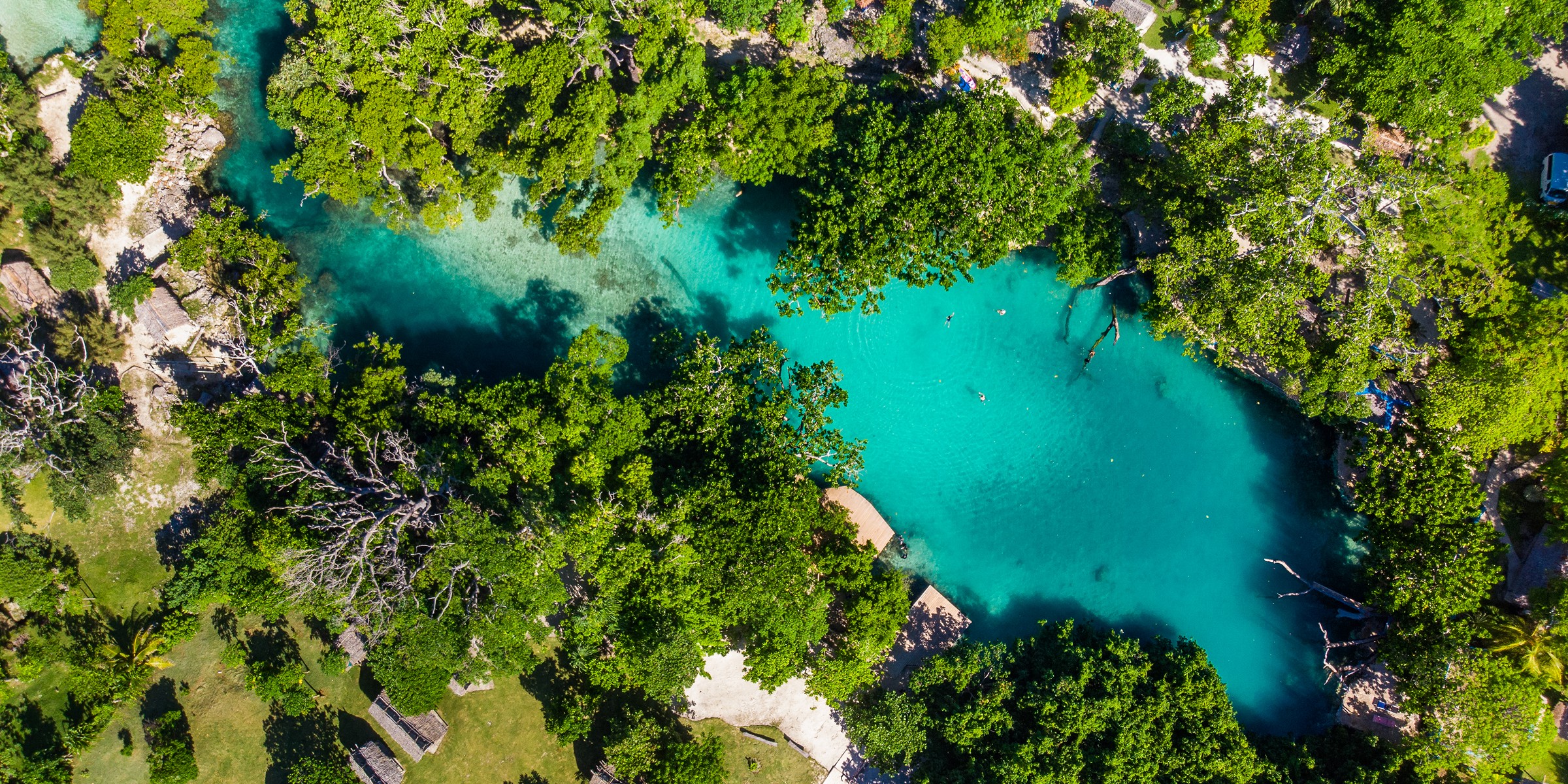 Aerial view of a turquoise blue hole lagoon in jungle, Vanuatu