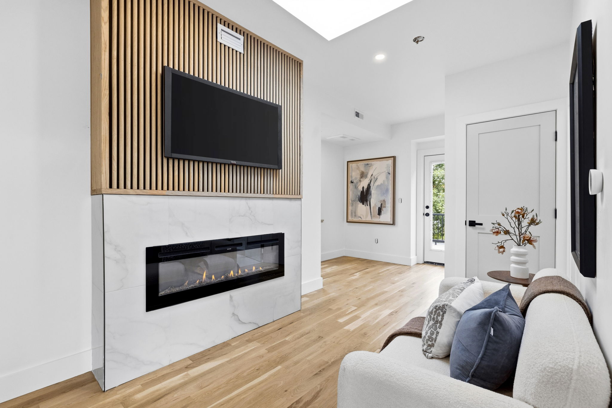Linear fireplace with wood-slat feature wall at 167 Albion Street