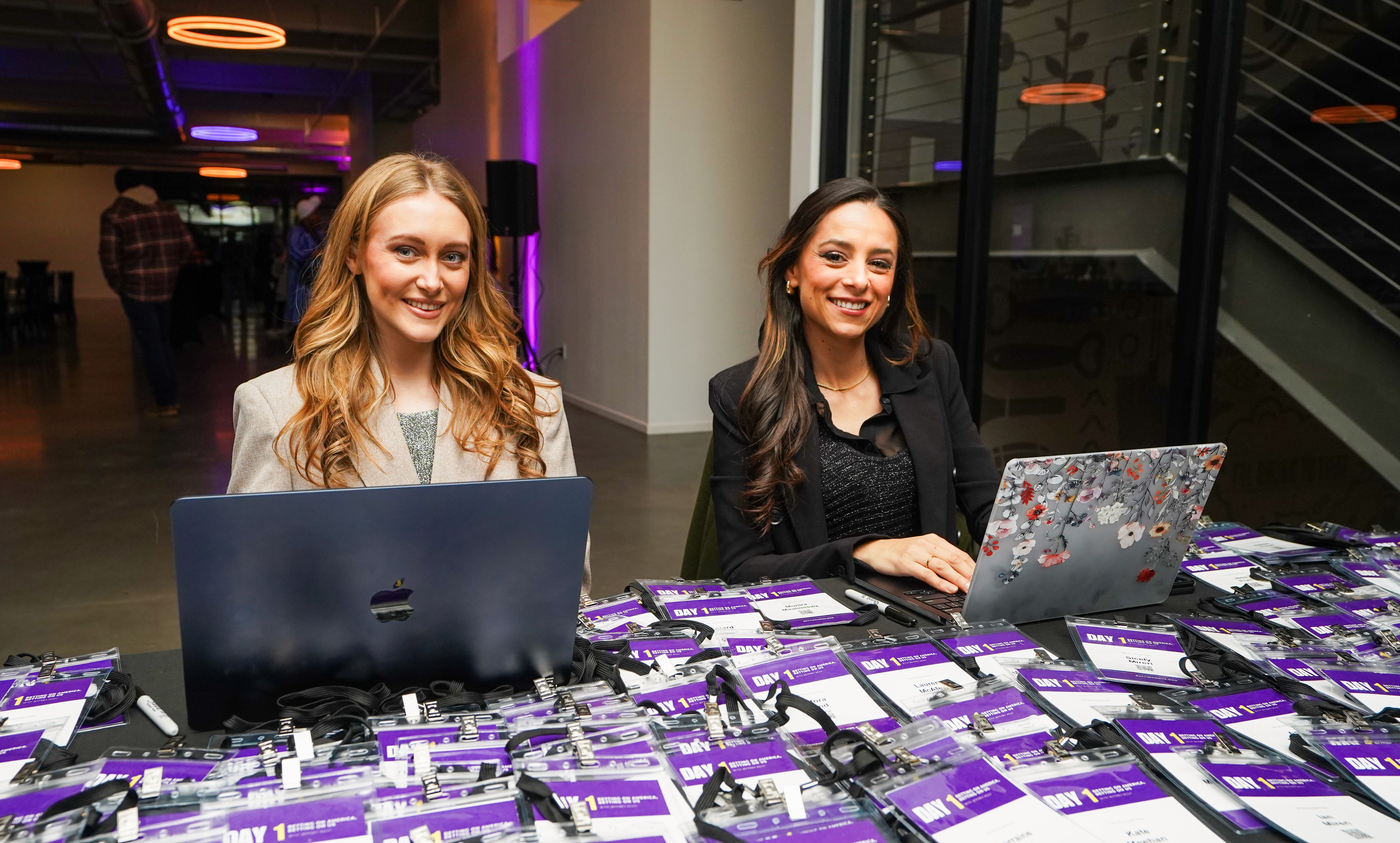 man in black crew neck t-shirt and blue shorts holding woman in white and red