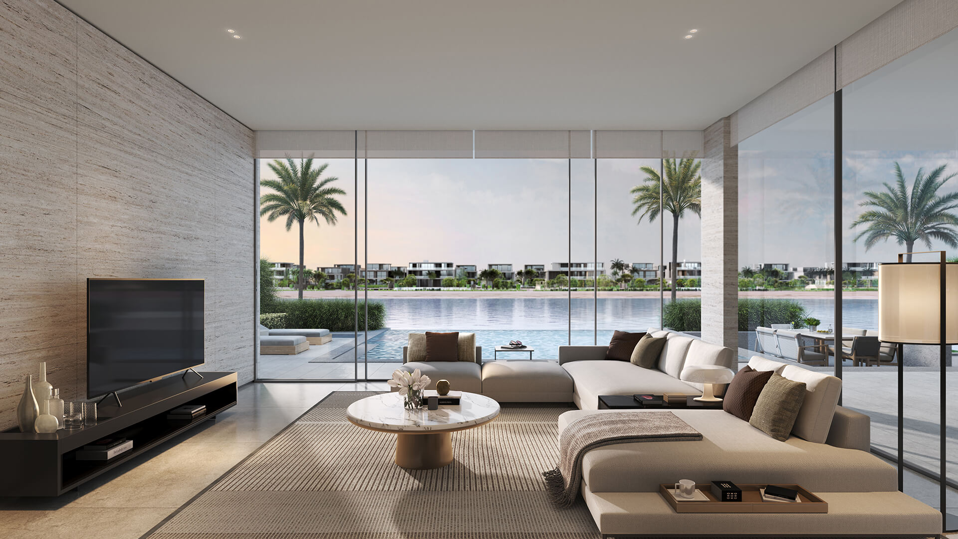 A modern living room featuring a large window with a view of the water, showcasing the elegance of signature villas.