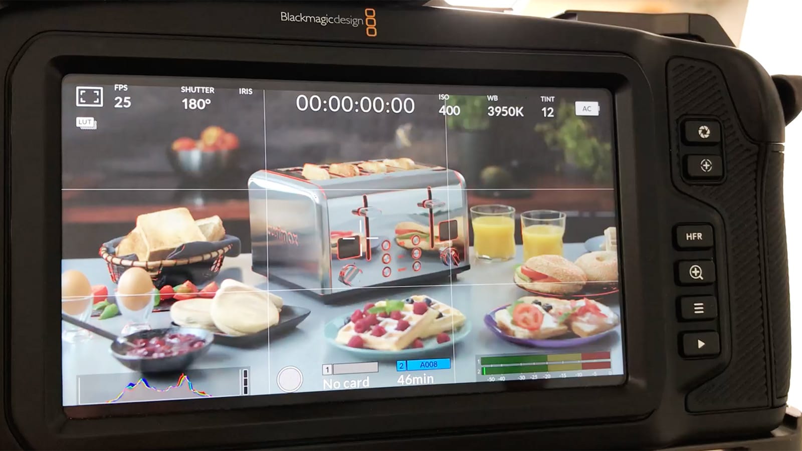 The camera monitor shows the kitchen equipment being filmed
