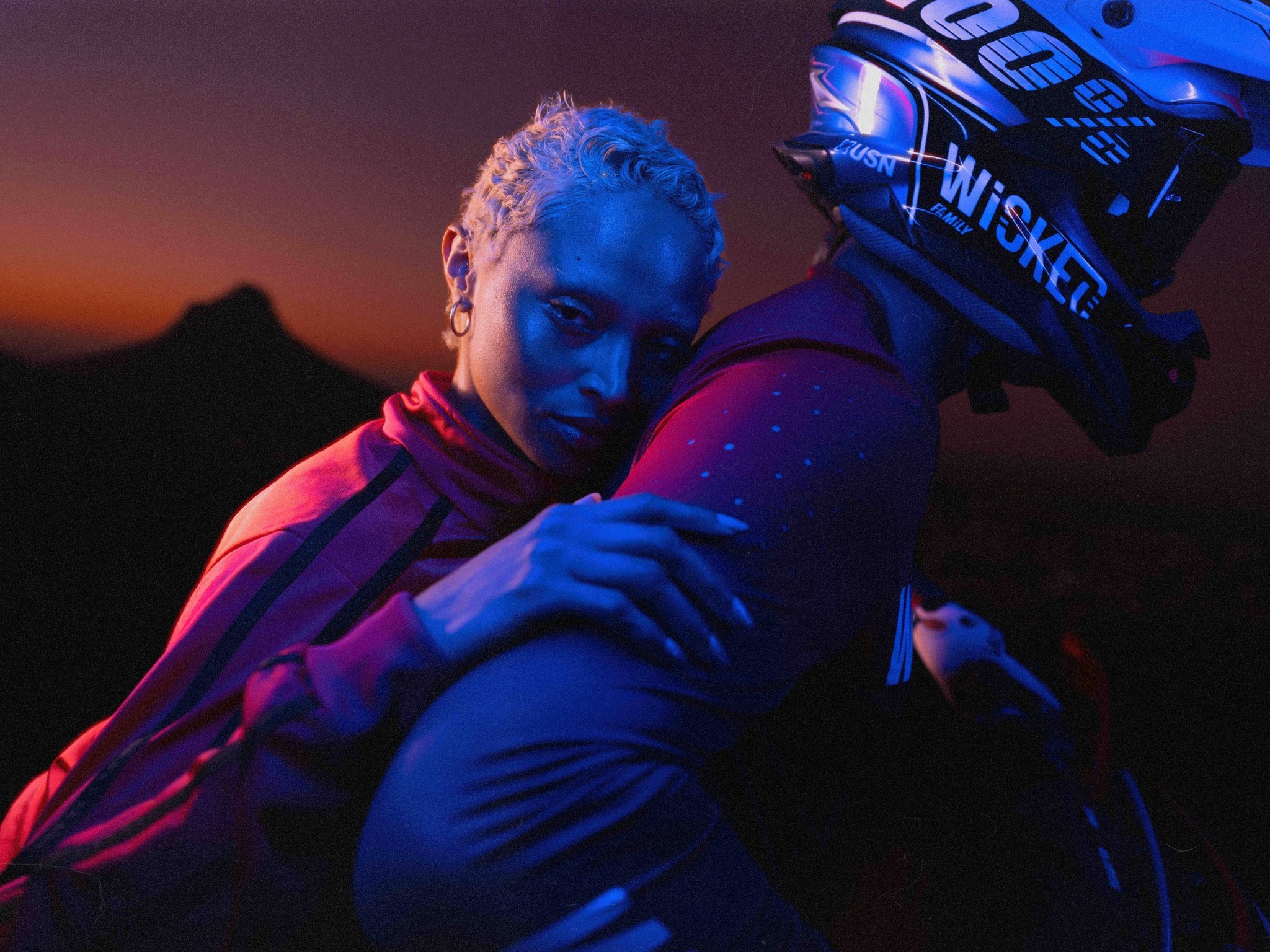 Kolja_Eckert_Wicked_Bikes_woman_embracing_motocross_rider_at_dusk