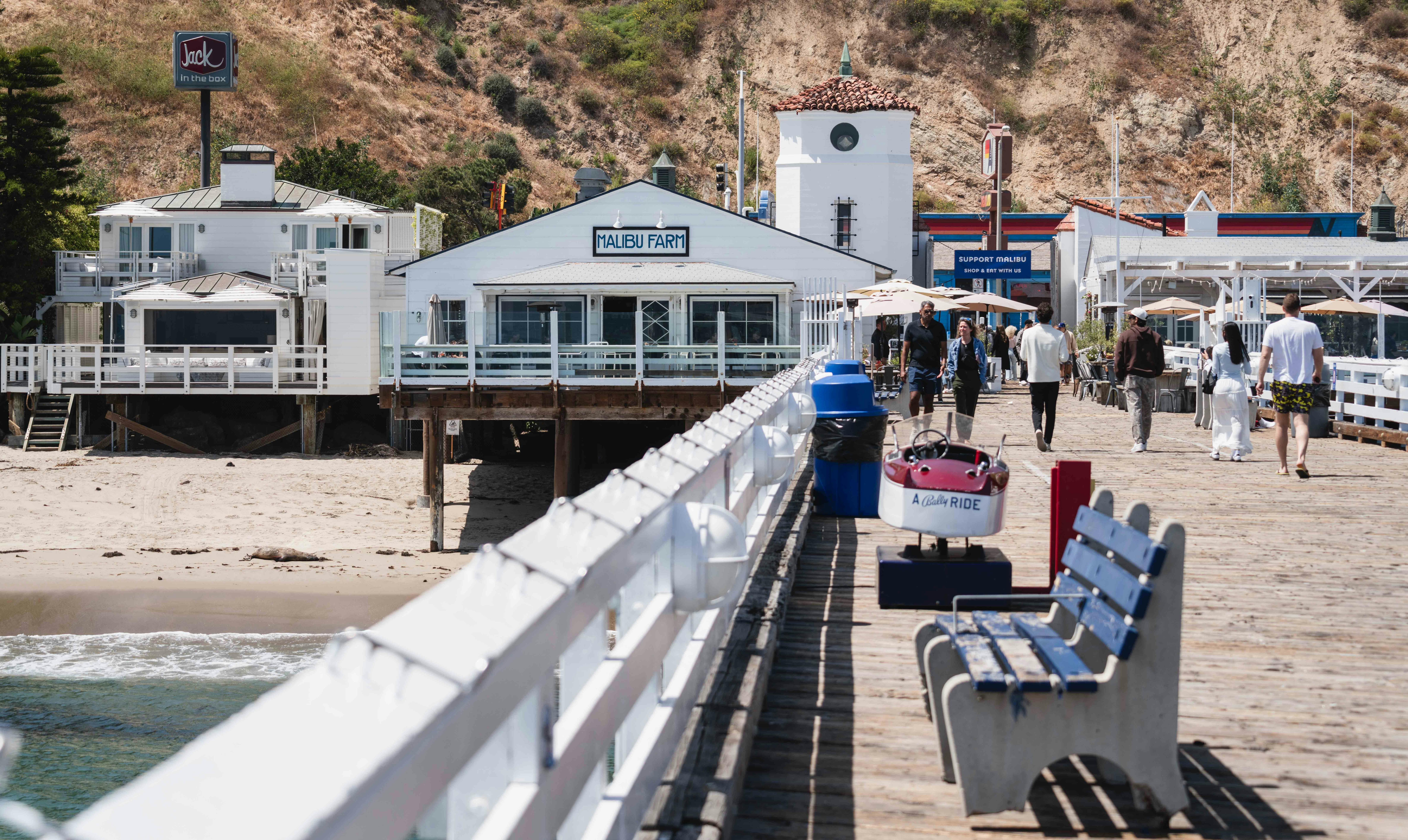 Malibu pier with people walking and benches – surfboard rental in malibu