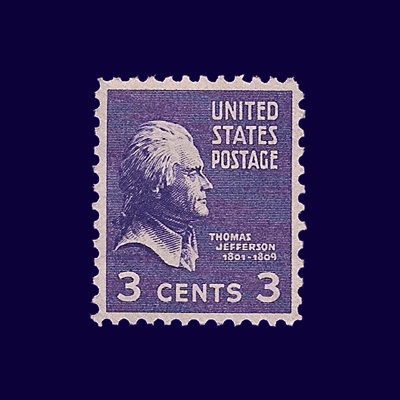 A young woman with long hair smiles while standing against a green backdrop, wearing a casual dark sweater.