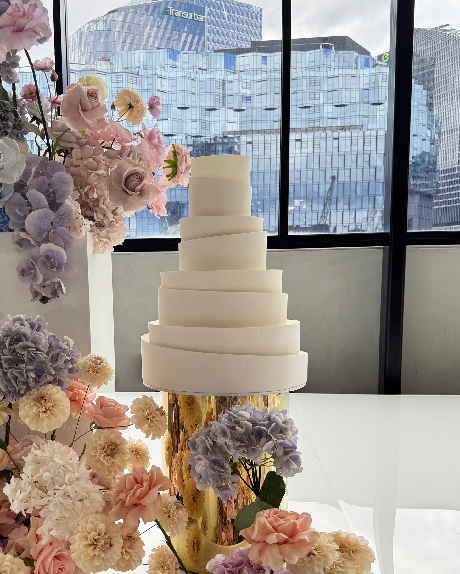 four tier wedding cake, minimalist in design with custom angled features.