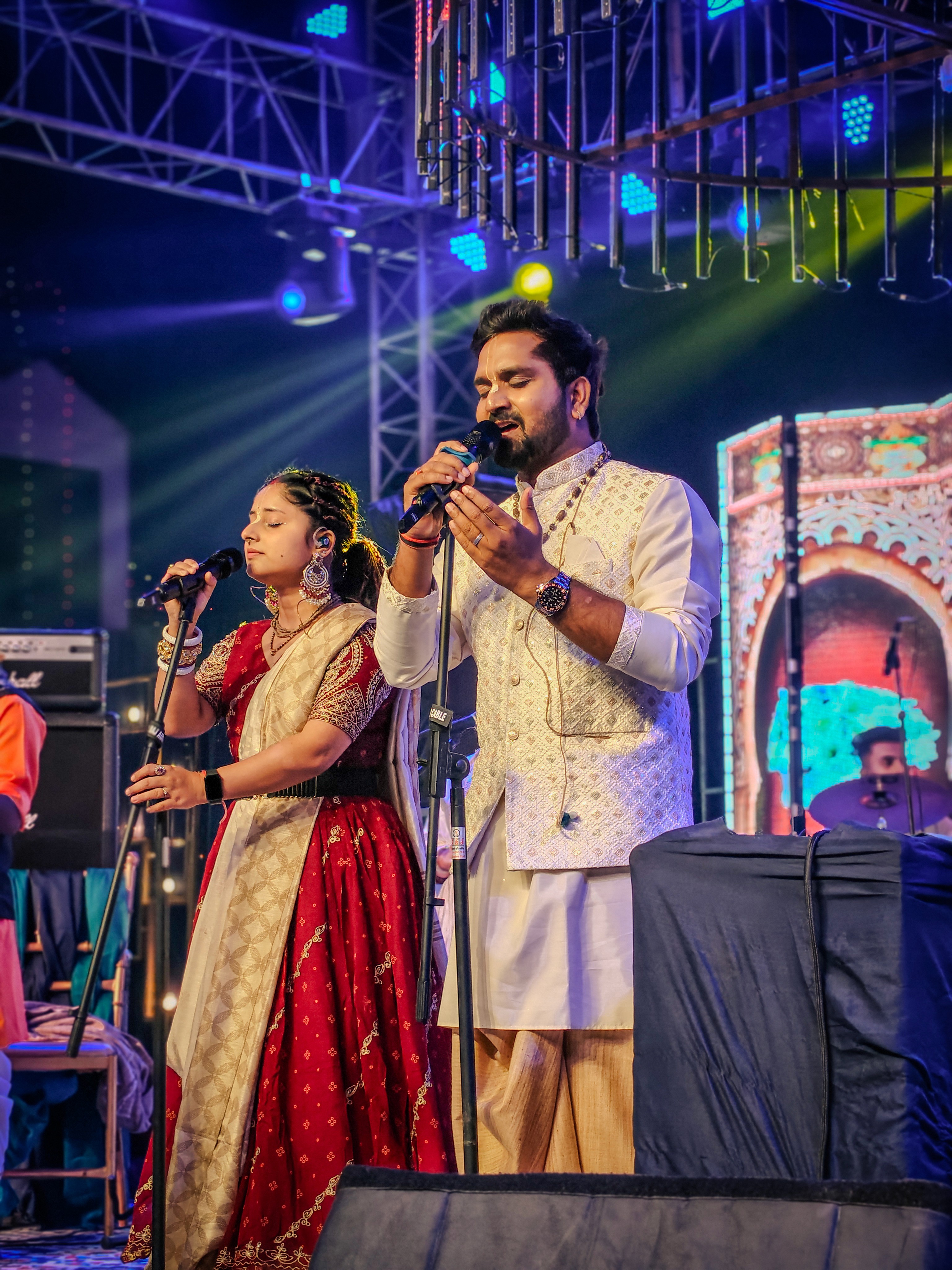 Man wearing sunglasses and headscarf in low light