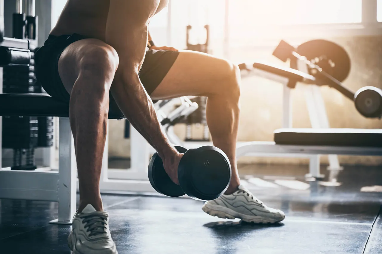 A man lifting a bar bell doing a workout