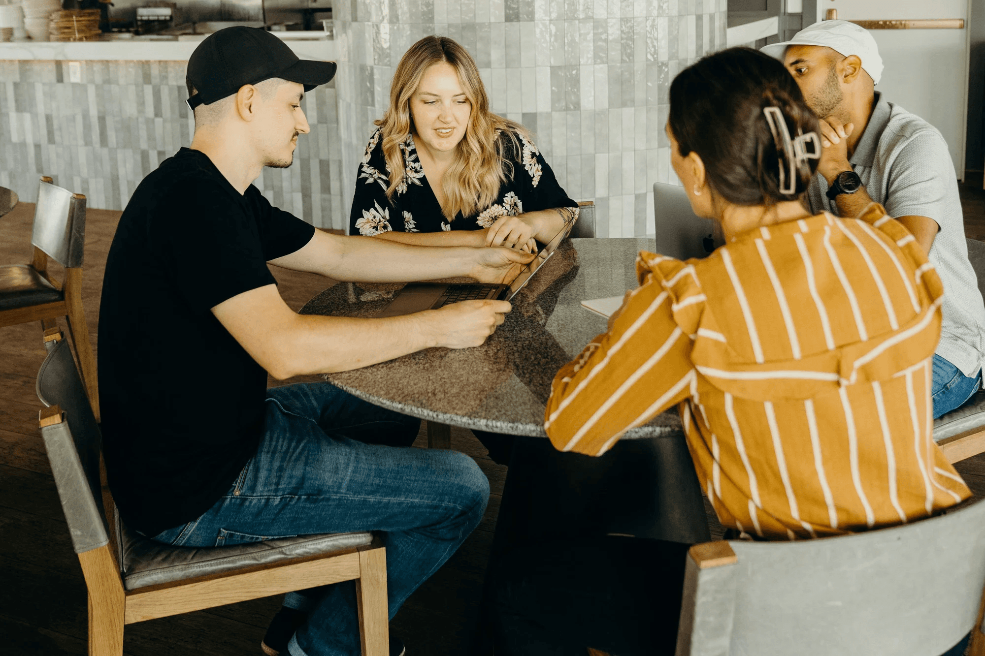 People sitting at a table with drinks and talking.
