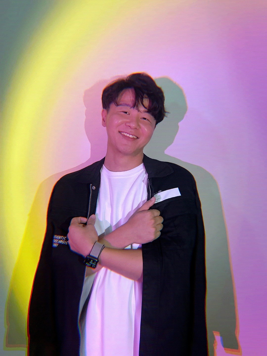 Portrait of a person in a pink sweater against a light background