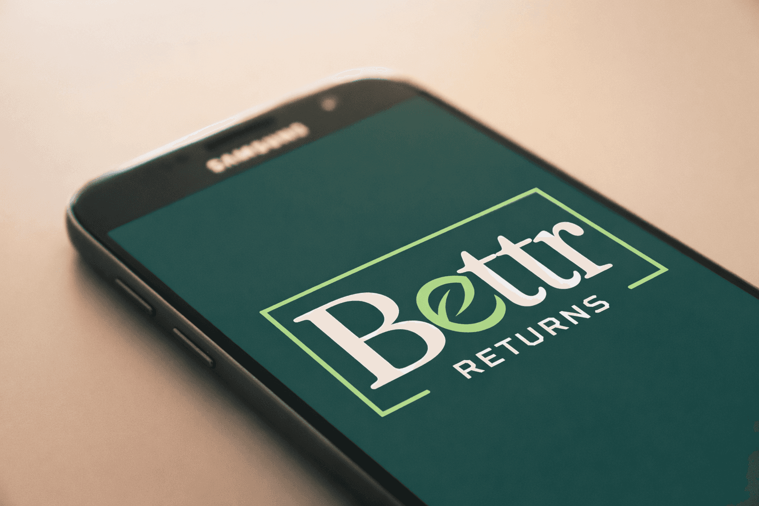 A phone with Bettr Returns logo on the screen 