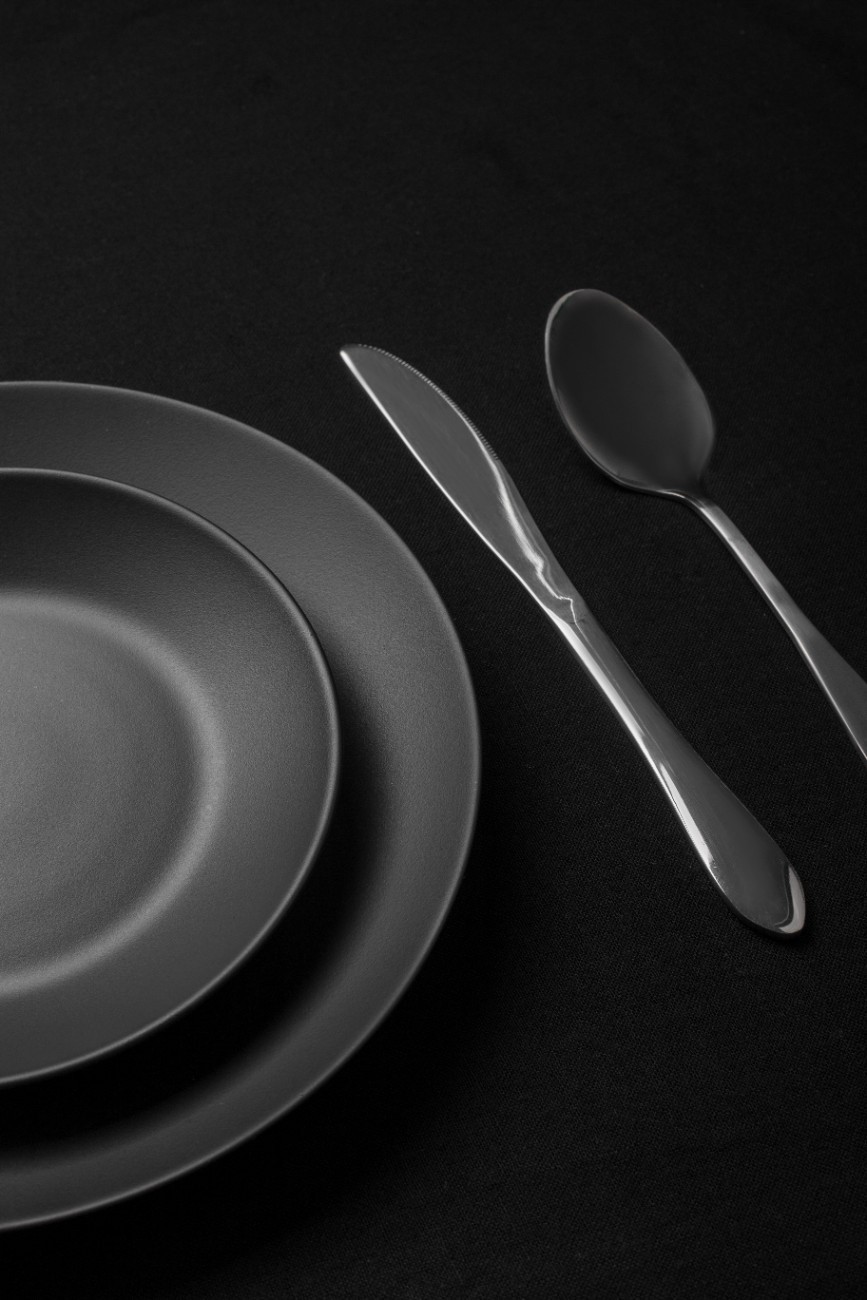 Minimalist interior with curved wooden staircase, rich wood textures, and soft ambient lighting.