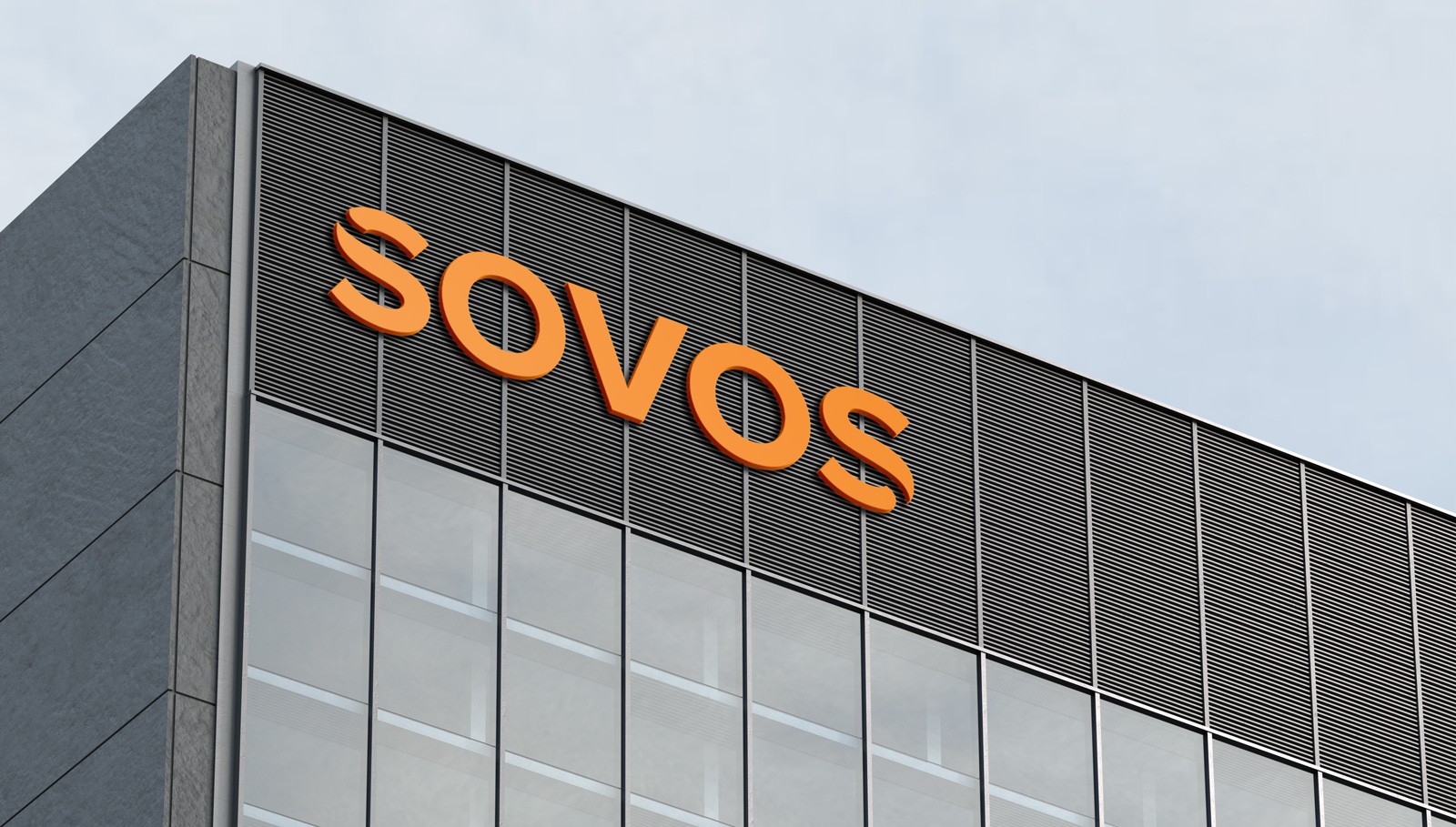 Exterior view of a modern office building with "SOVOS" written in large orange letters on it.