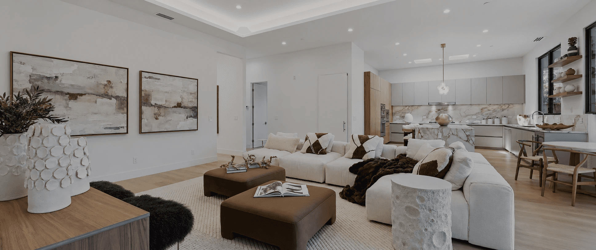 Interior of the Earthy Contemporary Home in Palo Alto, California, showing a Open-concept earthy contemporary interior in Palo Alto featuring a sculptural cream sectional and warm walnut accents.