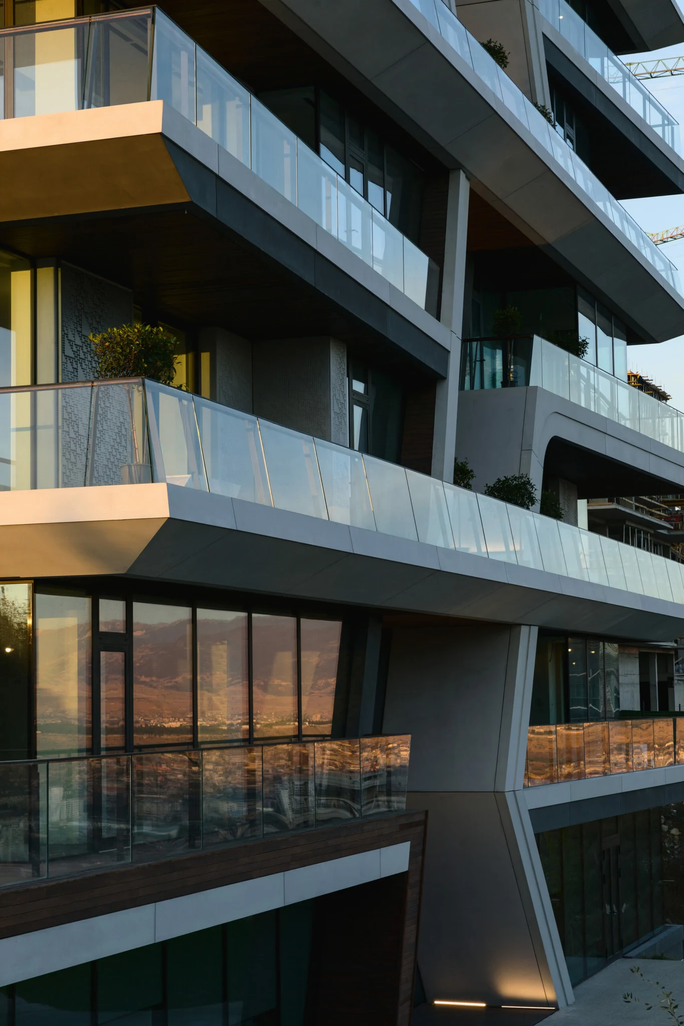 Modern architecture featuring overlapping balconies and a sleek design, creating a dynamic visual appeal.