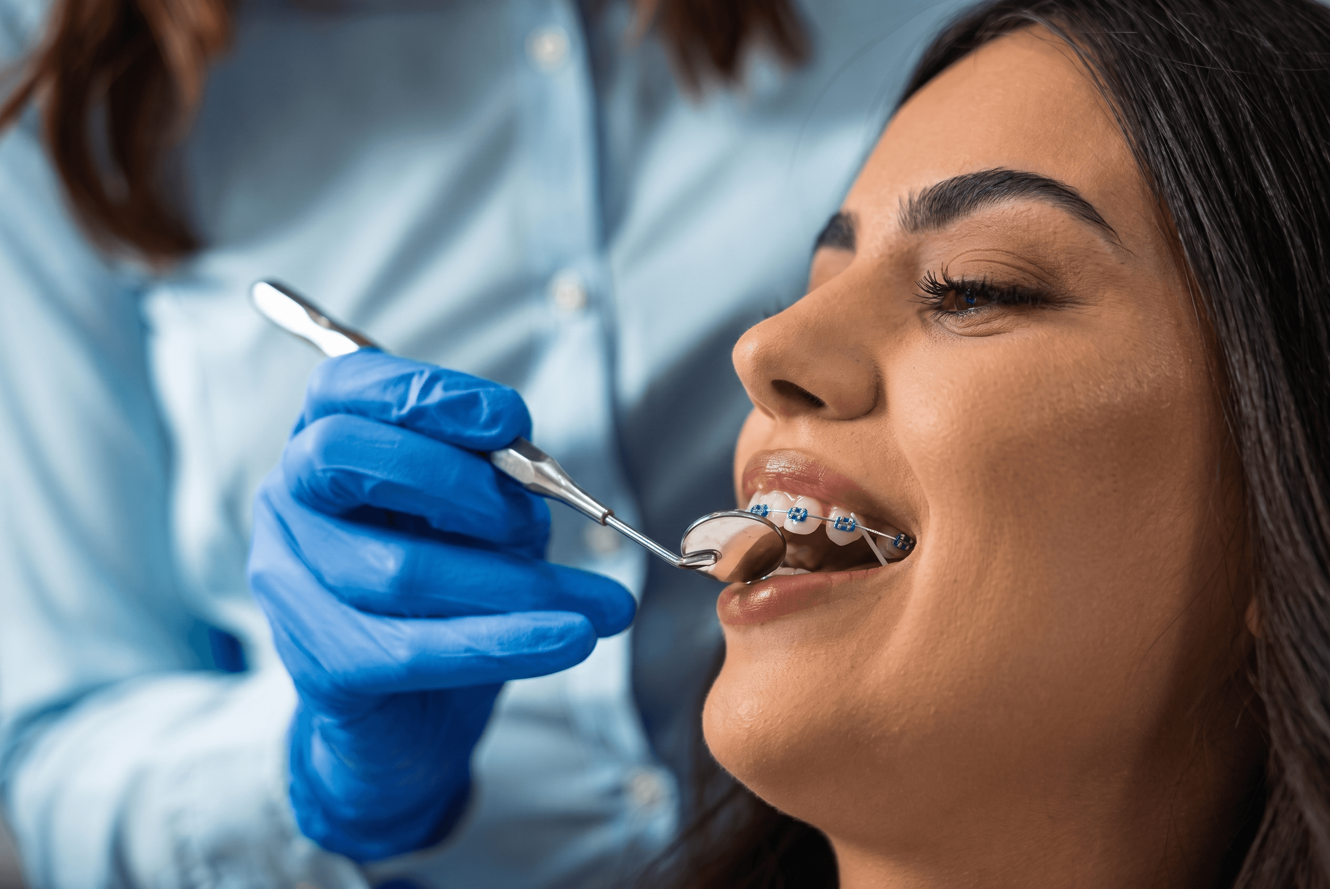 a man in a dentist's office holding a pair of scissors
