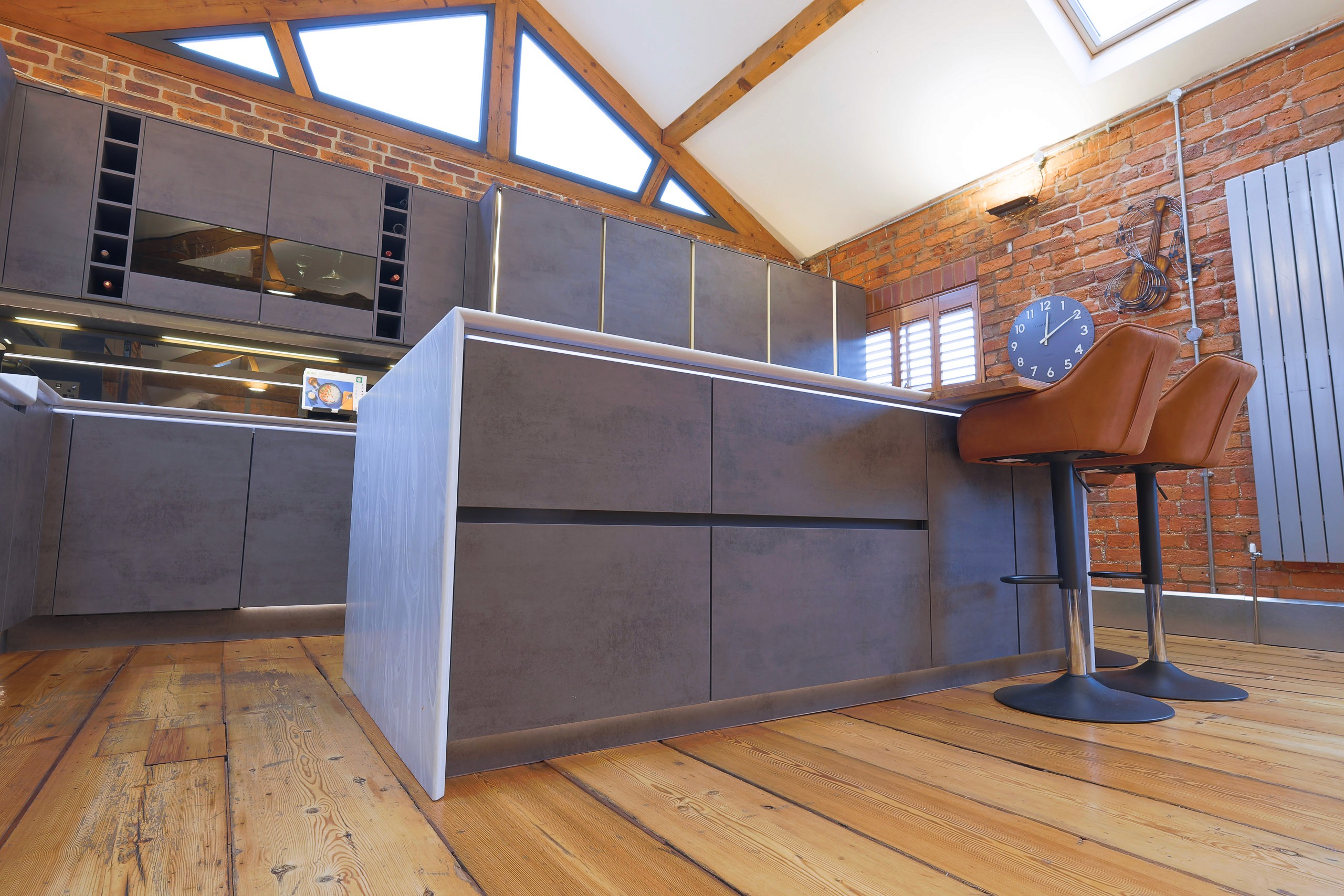 modern handleless concrete kitchen with corian worktops in wilmslow cheshire 
