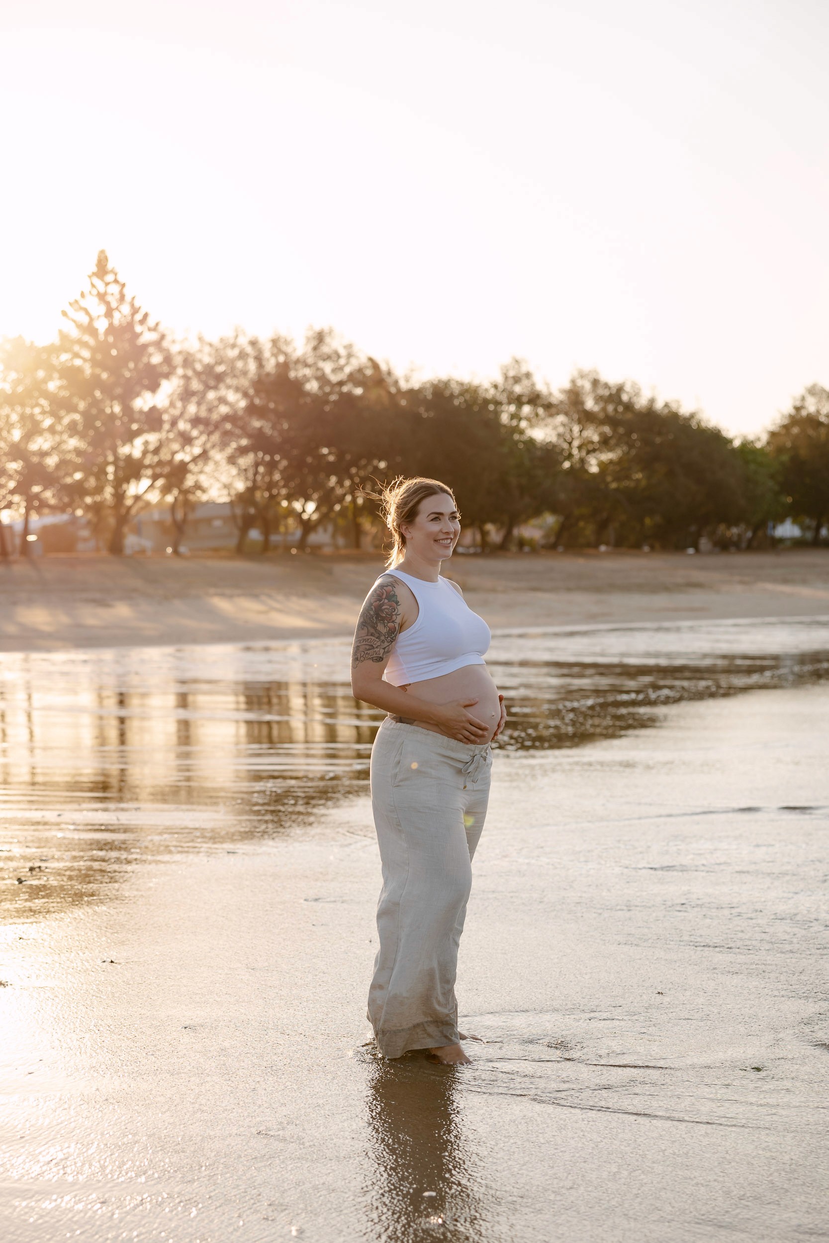 Pregnant womant at maternity photoshoot on the beach at sunset