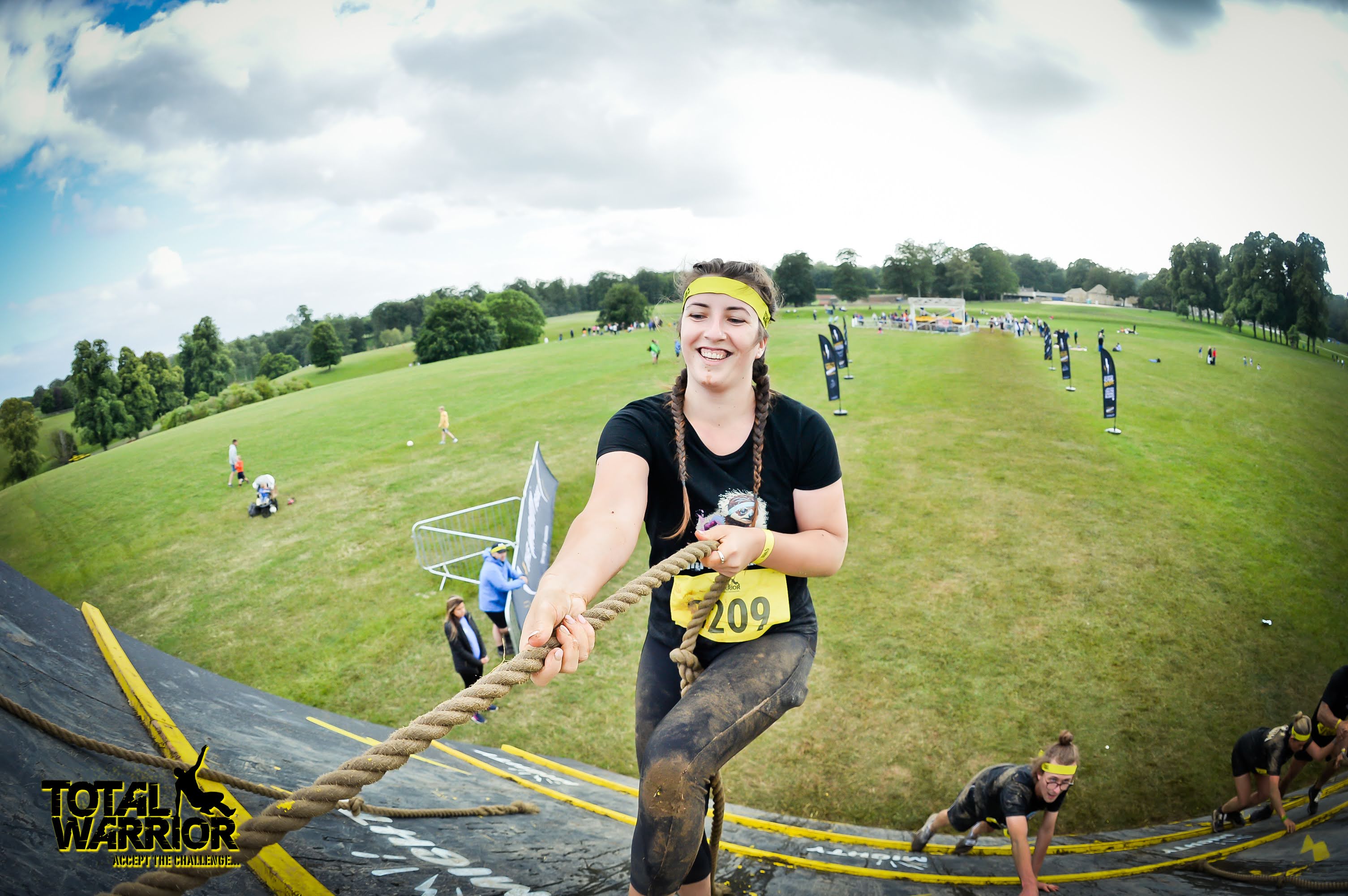 Runner covered in mud smiling.