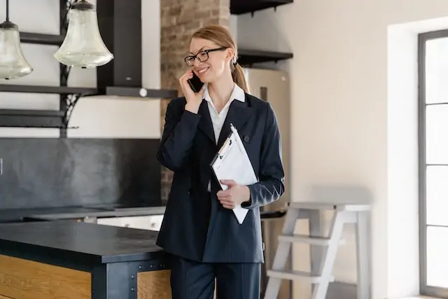 a property manager standing an available rental talking on the phone