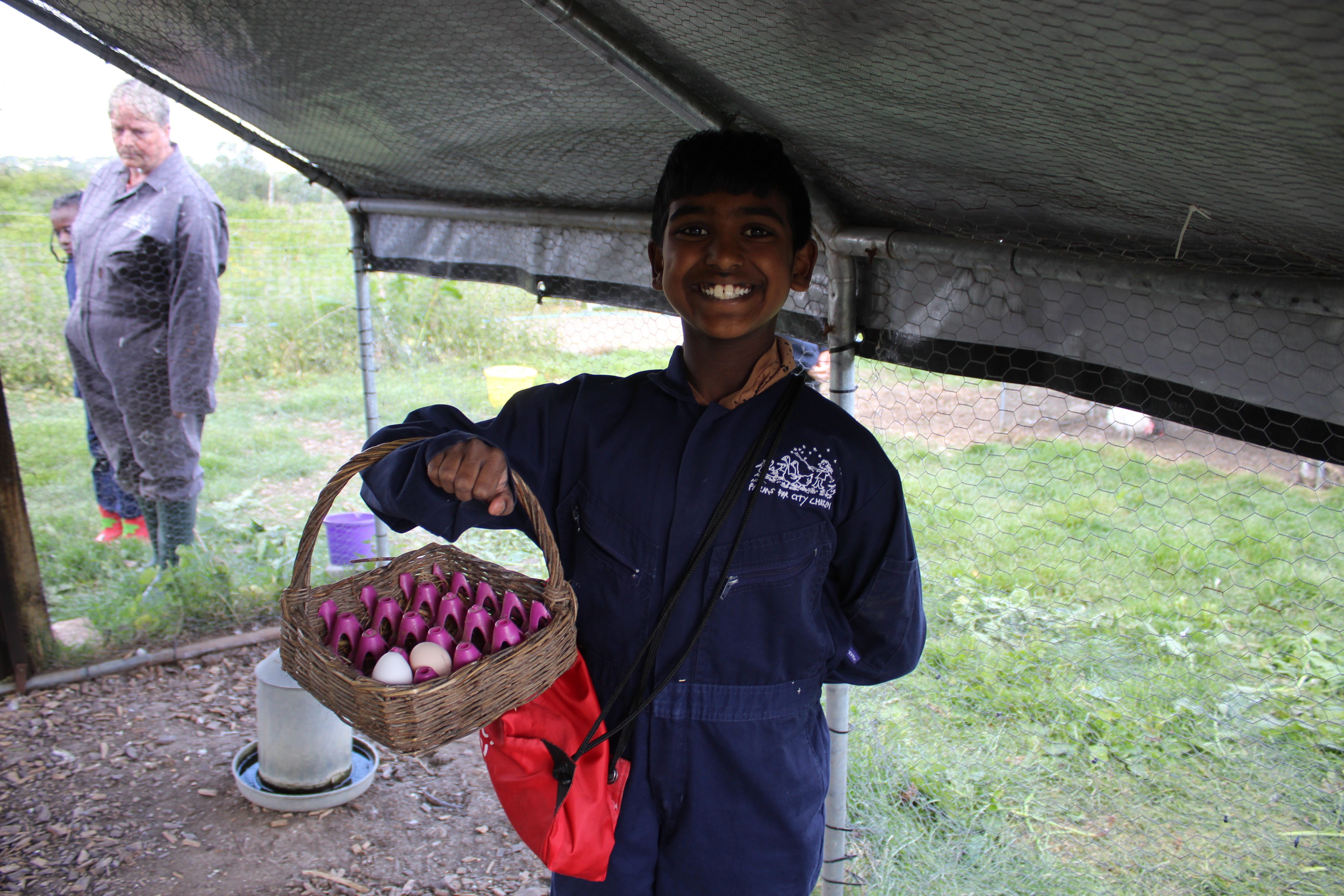 A boy holding a basket containing eggs