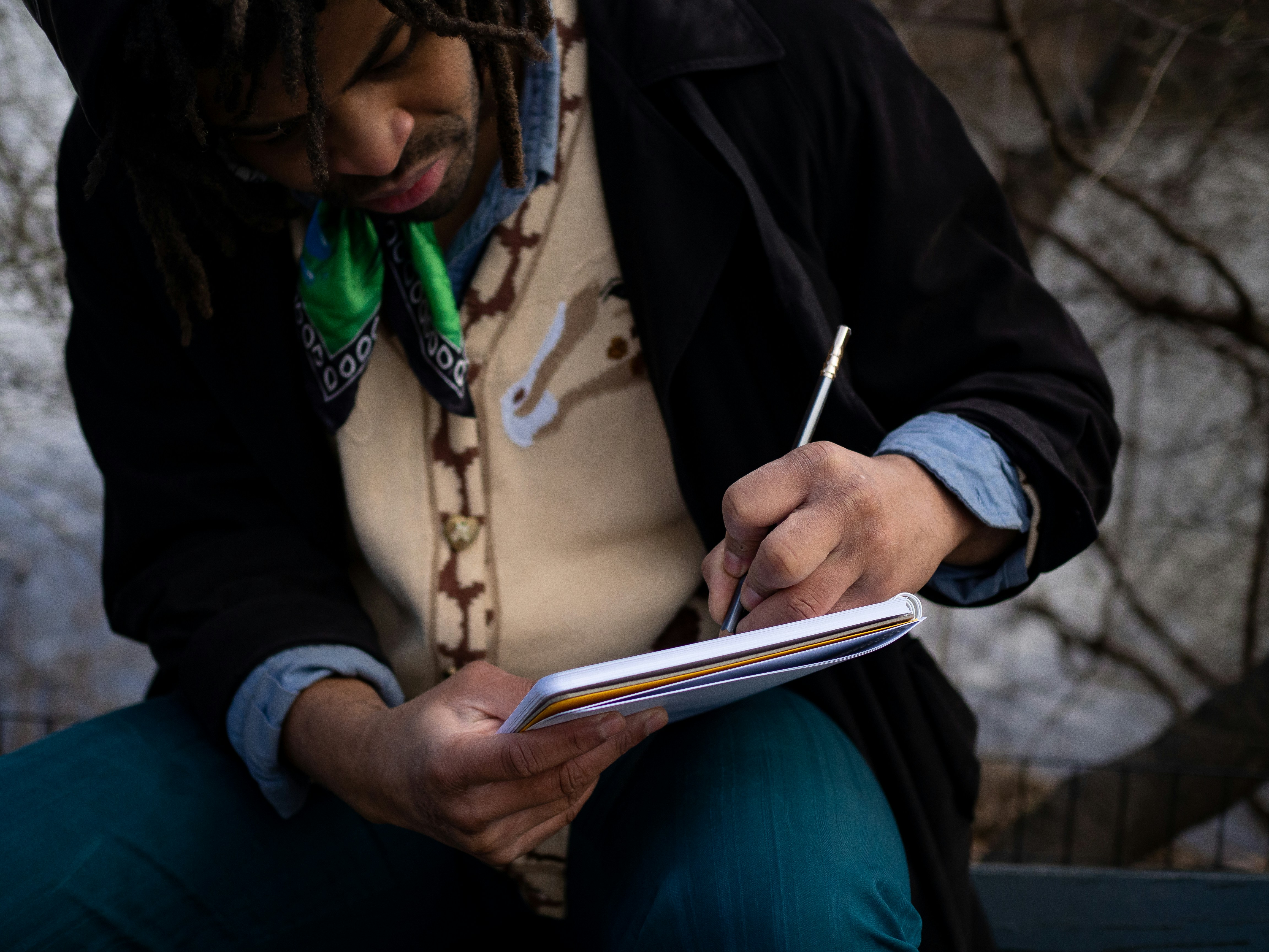 man writing in a notebook