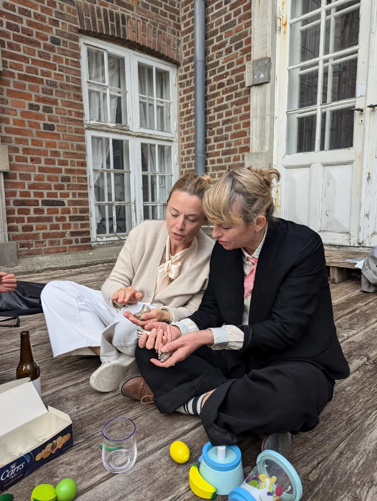 Louise Iuel Albinus aka Duddi, owner of Valdemars Slot, and Pernille With Madsen looking at casts of tiny feet.