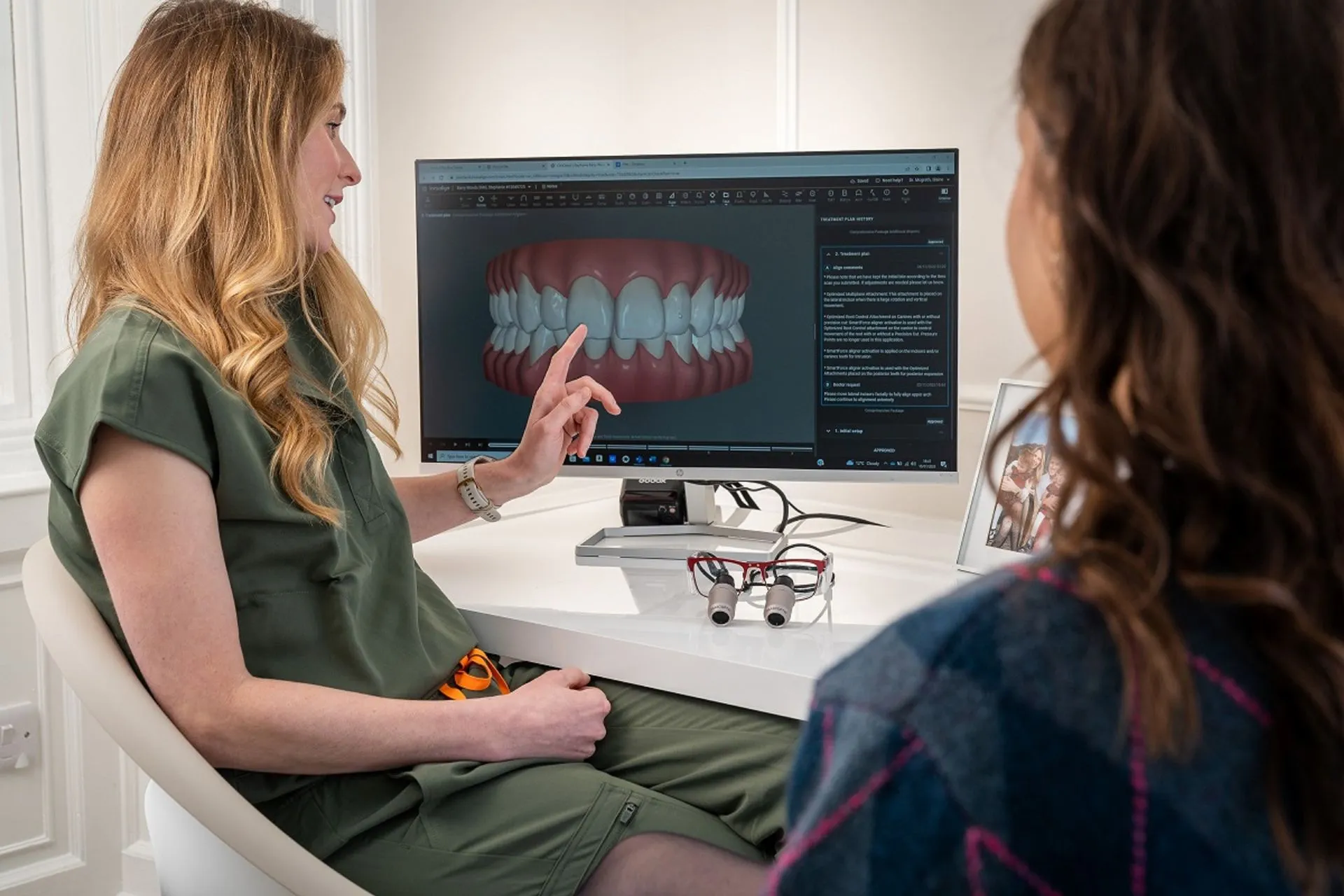 Dentist explaining digital dental scans to a patient during a consultation