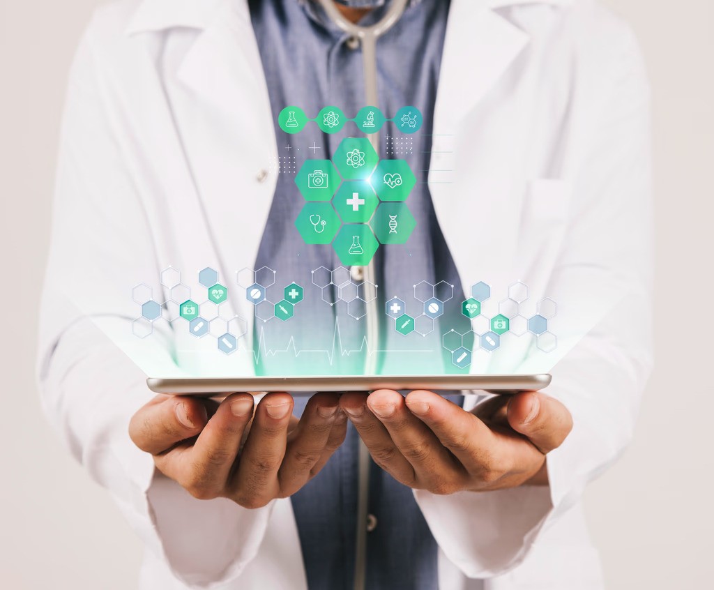 A winding road cuts through rocky terrain, surrounded by patches of green grass and illuminated by sunlight.