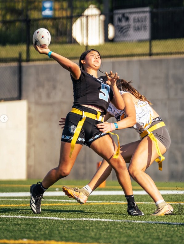 Girls flag football players competing
