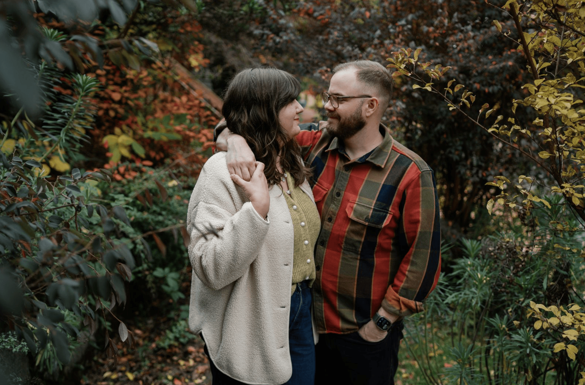 Couple sitting in front of a lake with swans