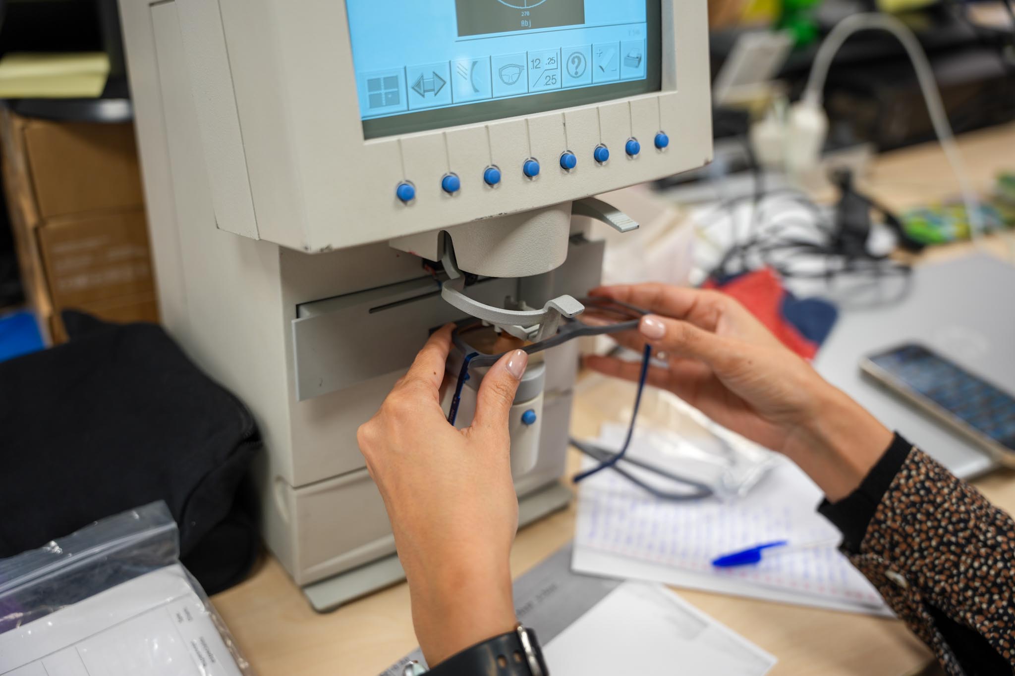 Dynamic close-up of a runner’s foot mid-stride on a muddy forest trail, wearing black socks and red trail shoes with visible sole pattern.