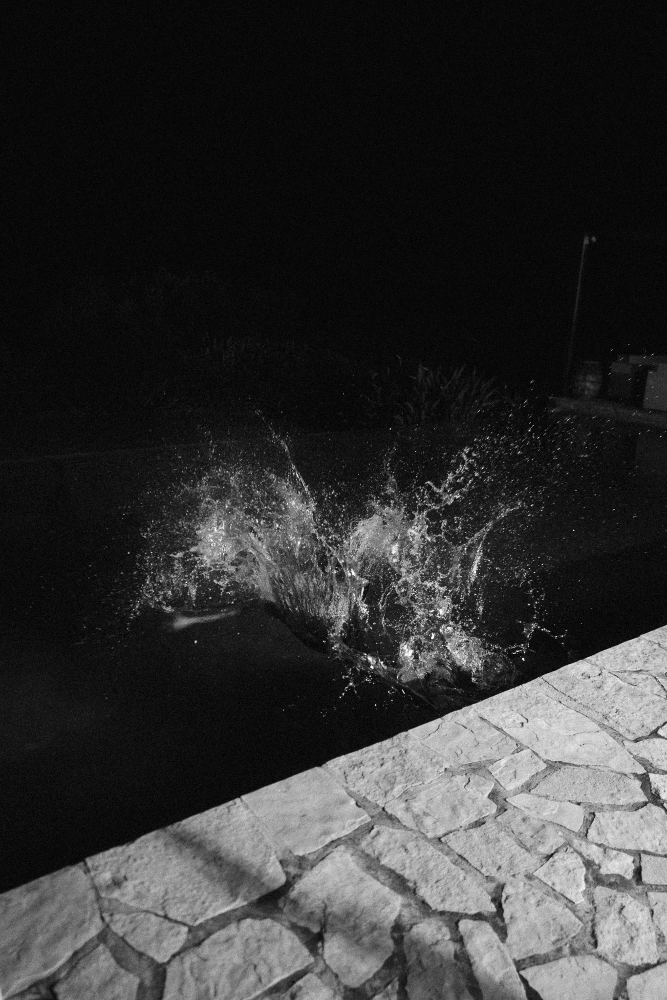whater in mallorca, grey picture of a pool with whater splash