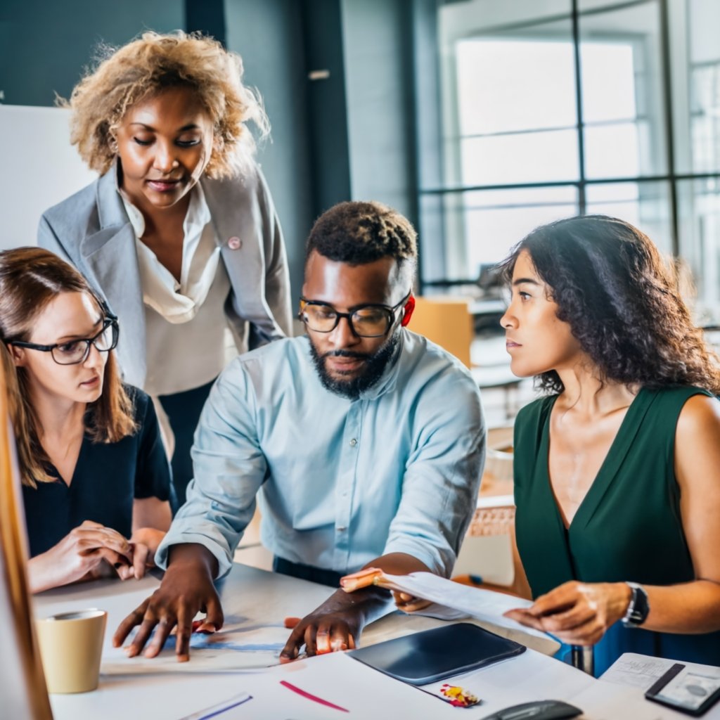 A diverse group of professionals engaging in a collaborative discussion in a modern American workspace, exemplifying the opportunities available through work visas in the USA.