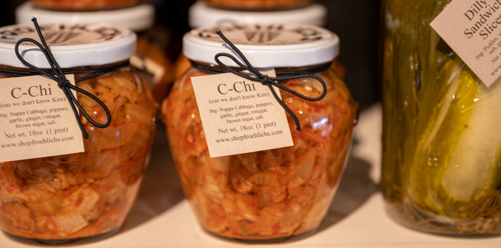 Labeled jars of fermented pickles and vegetables, a natural source of live cultures that add variety to a gut-supportive diet.