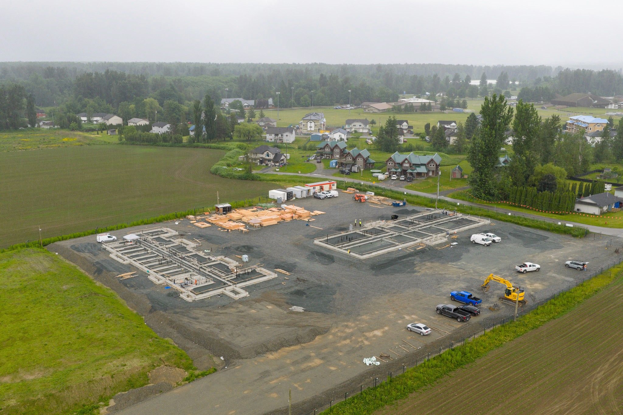 Construction site in Chilliwack, Fraser Valley, British Columbia, with foundations and HVAC plumbing work.
