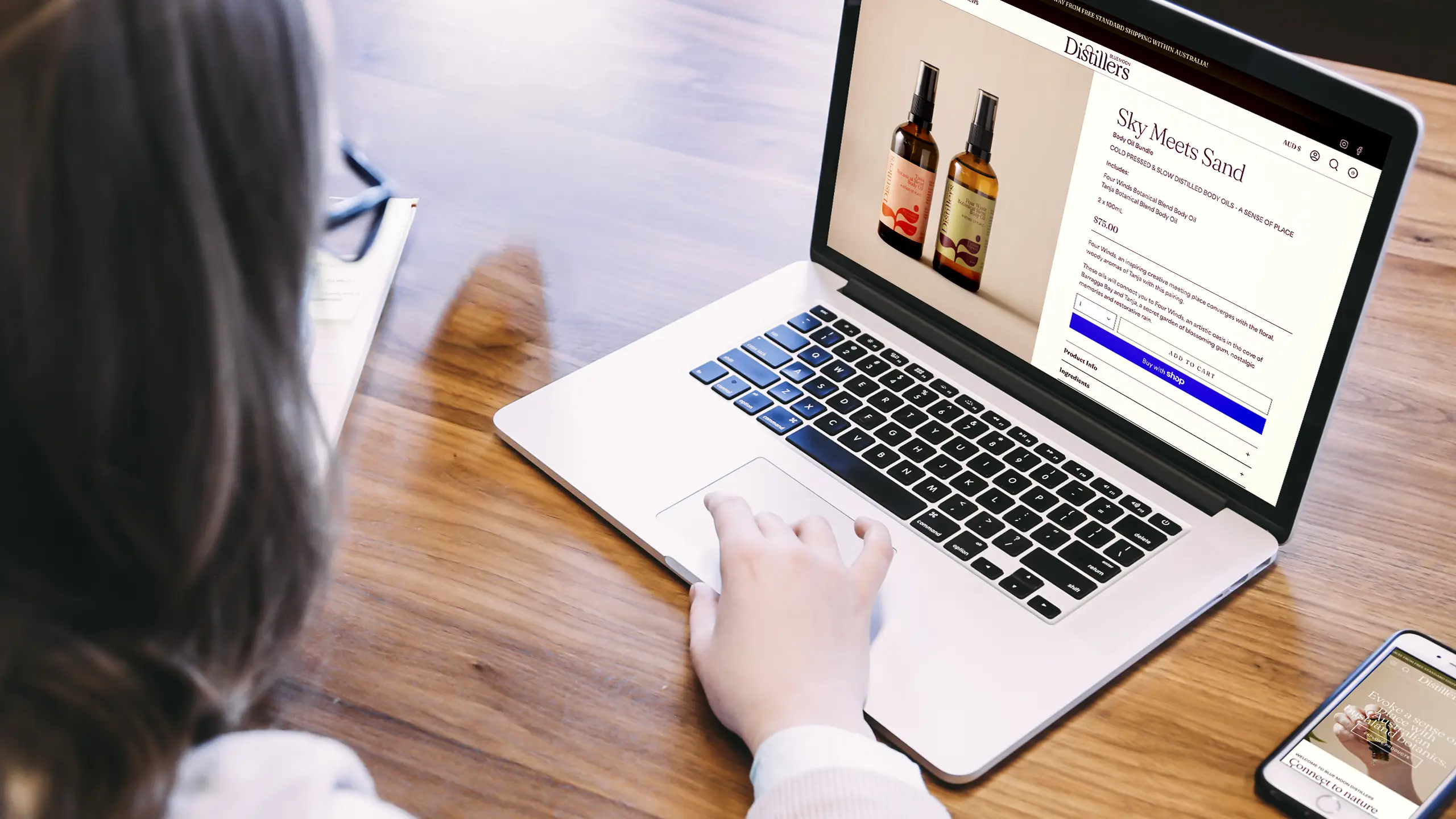 Blue Moon Distillers Shopify website product page in laptop view displaying brand palette and typography.