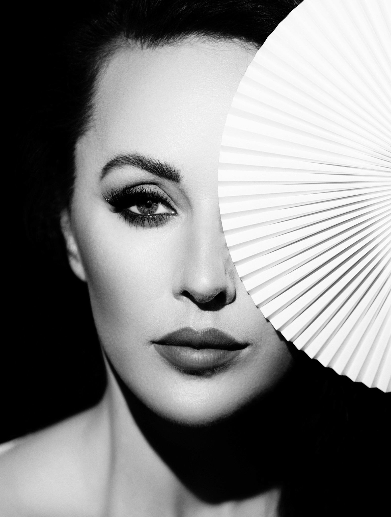 Woman's face partially covered by a fan, artistic portrait - The Fan - Agnieszka Czyzkowska Photography