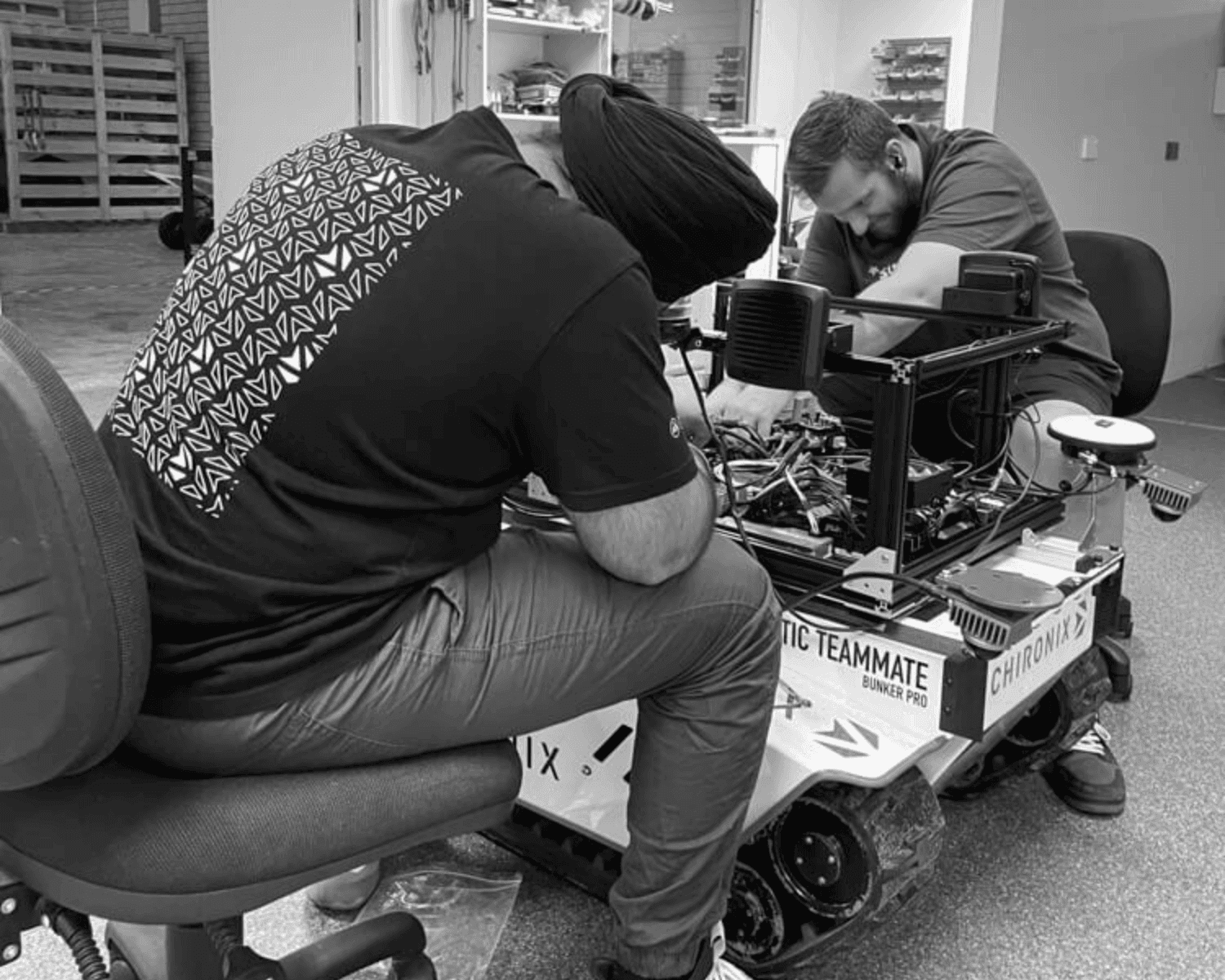 two boys working on a robot