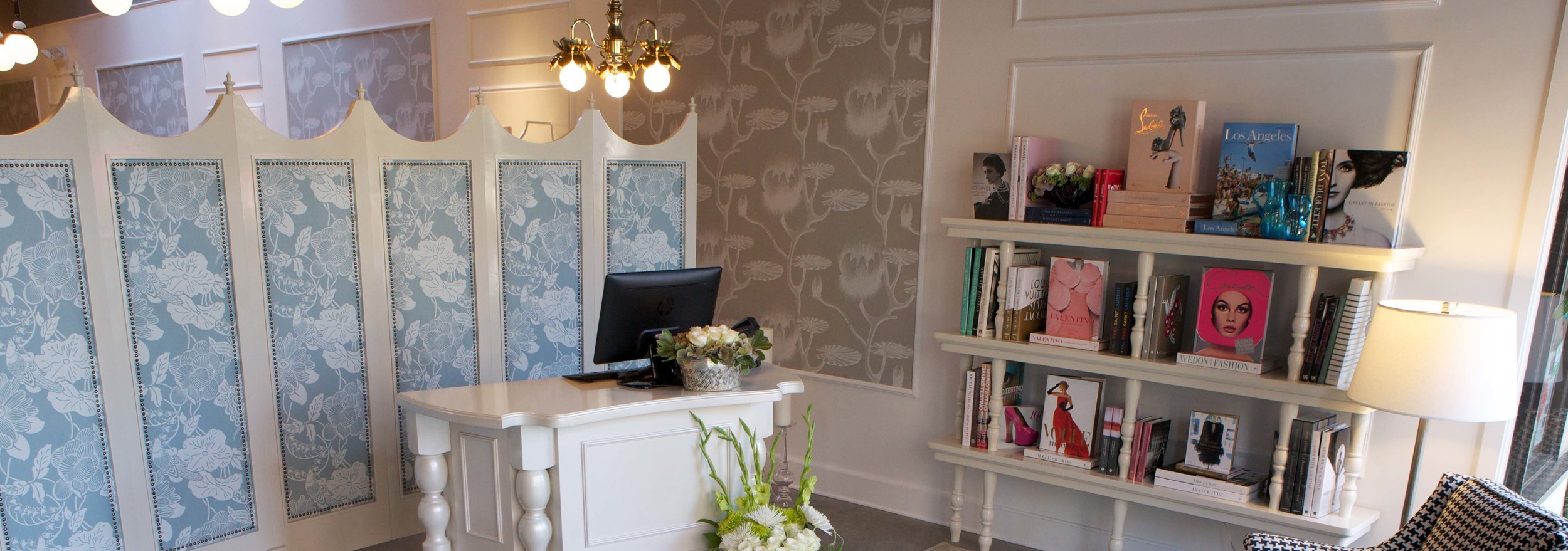 Regne reception lobby with patterned panels and display shelves.