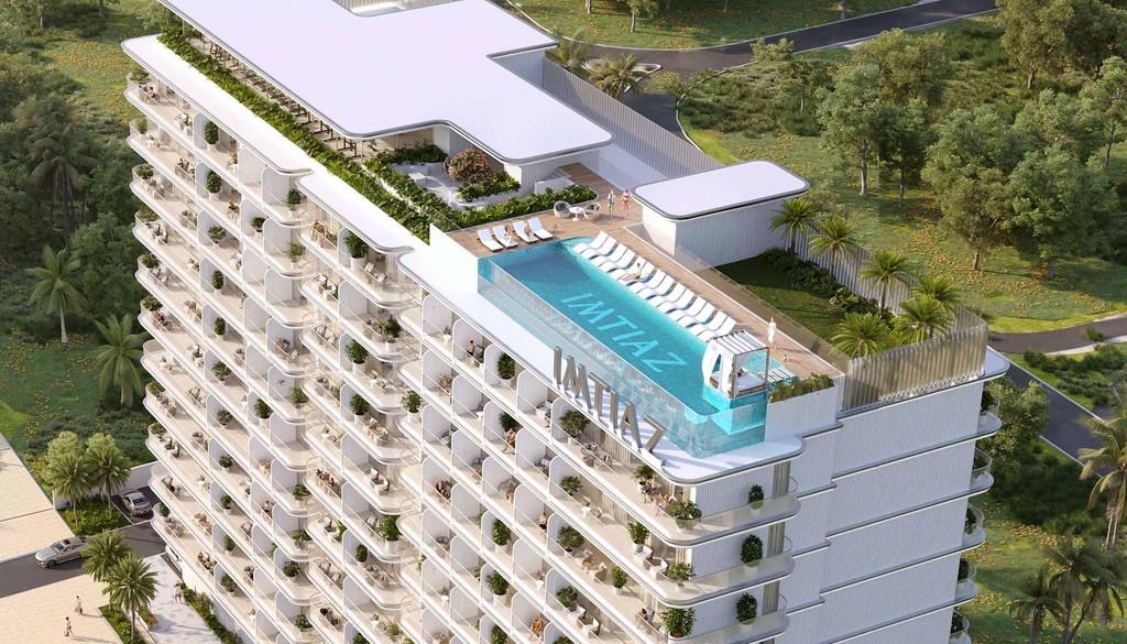 Bird's-eye view of the Cove Edition 6 luxury apartment complex, featuring contemporary architecture and lush surroundings.