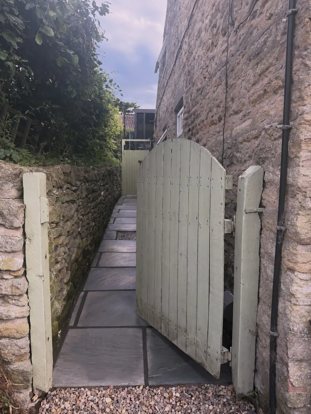 Indian stone patio and black pergola at the finished Airbnb garden in York