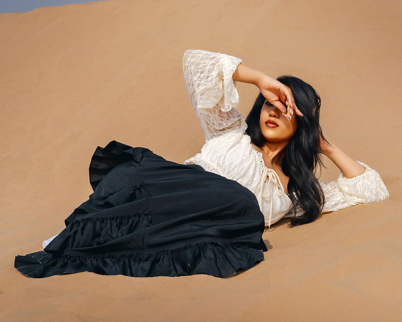 Golden hour desert photoshoot with soft light and elegant styling
