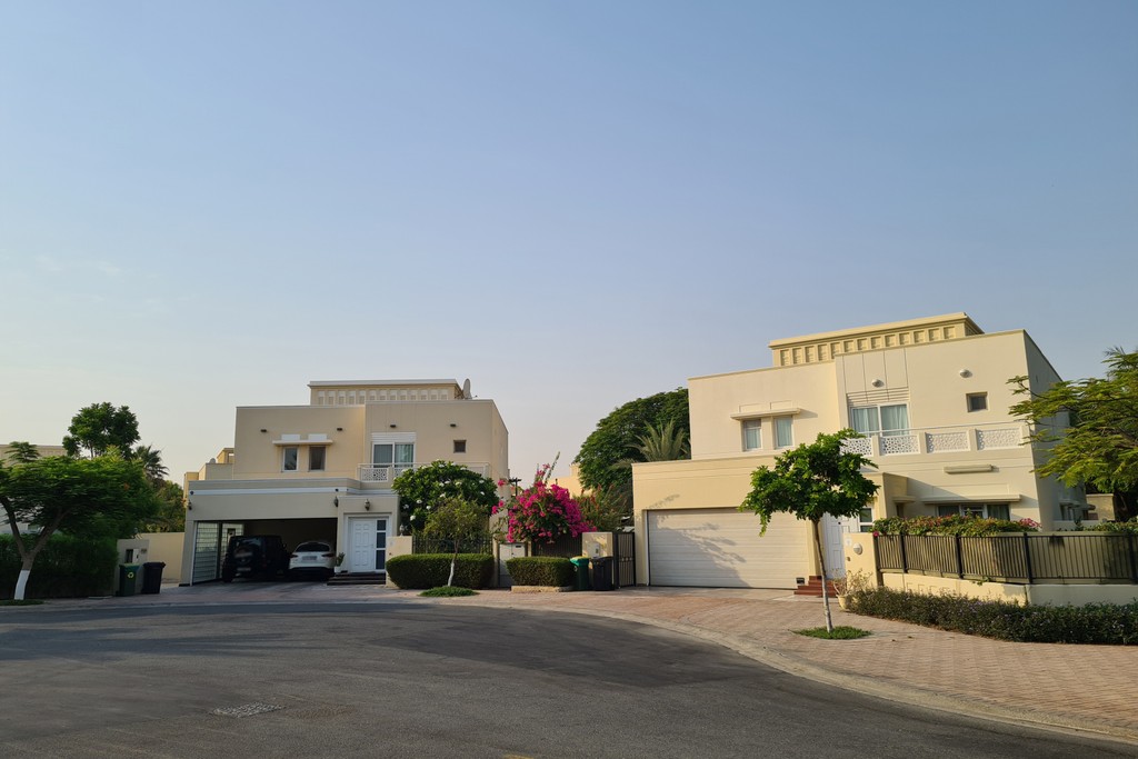 Overhead perspective from Palm Island Resort, displaying the greenery of Meadows 9 and the urban landscape of Dubai.