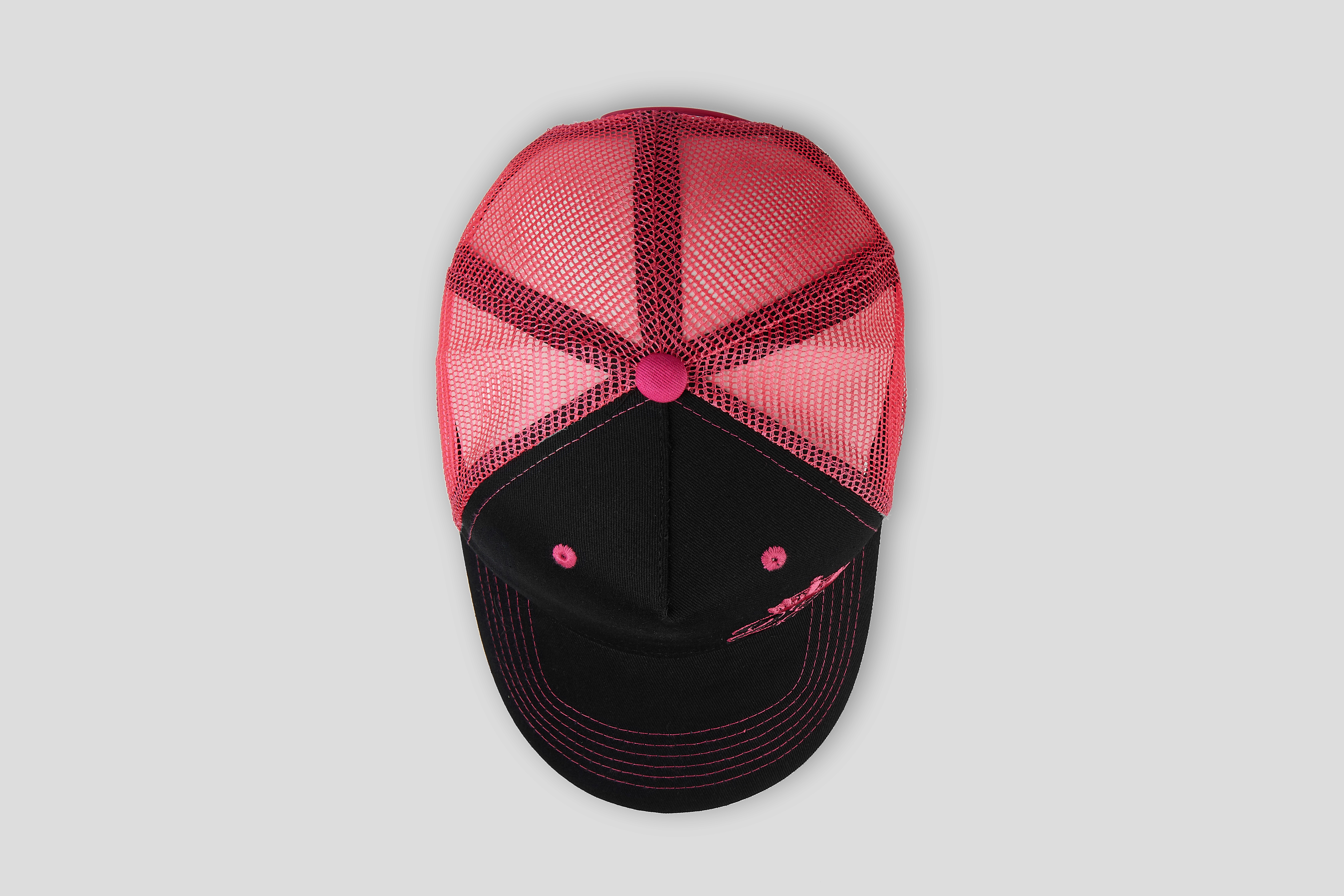 Close-up of a blue trucker hat featuring a mesh back and a colorful rectangular patch on the front panel, set against a white background.