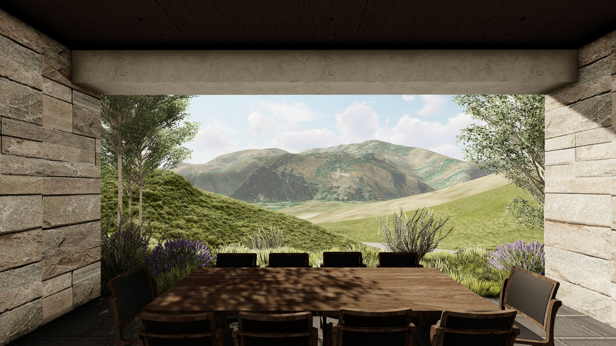 Outdoor dining area with a wooden table and chairs overlooking rolling, green mountains.