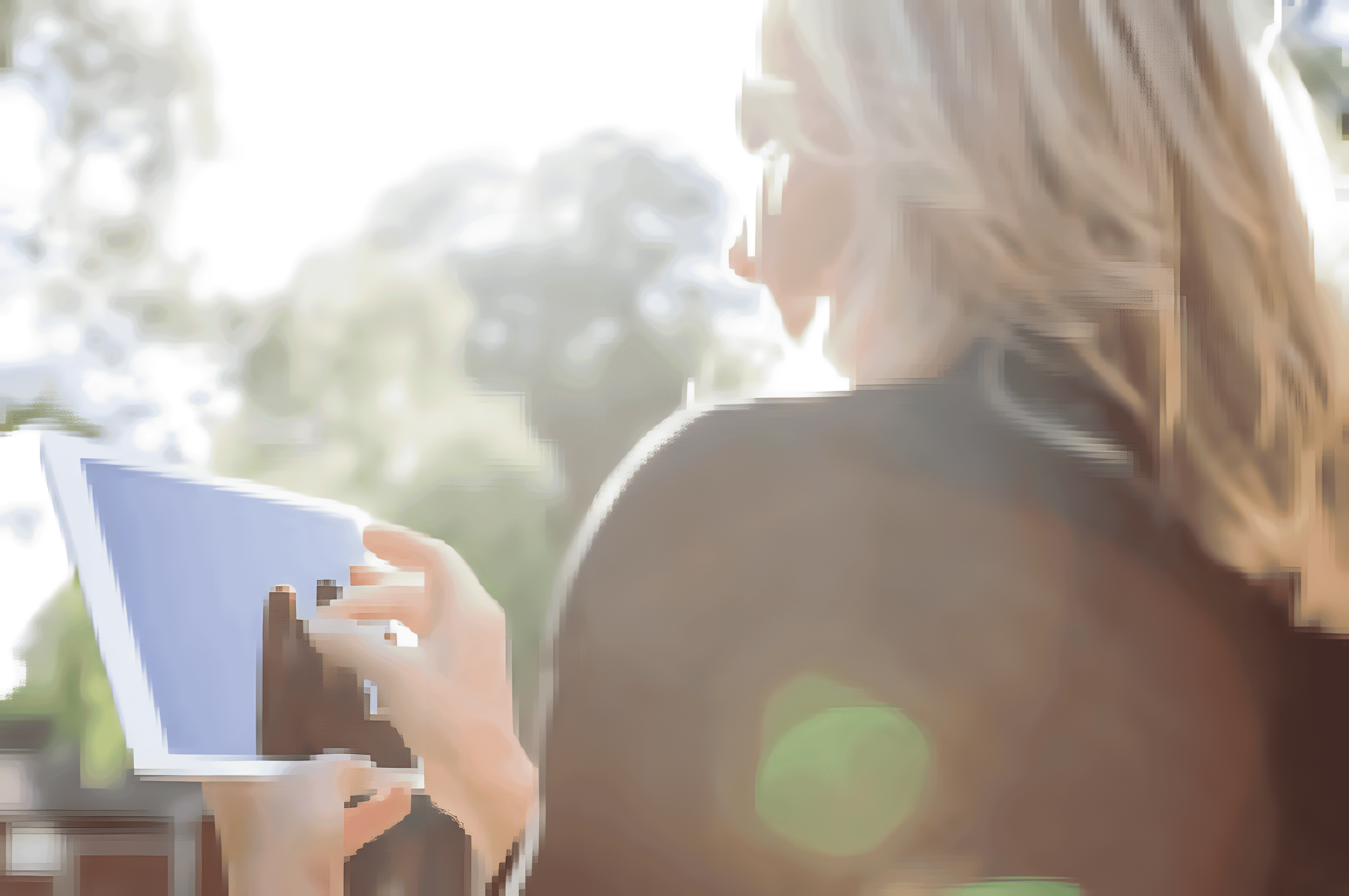Aerial view of a winding road cutting through rocky terrain with patches of grass.